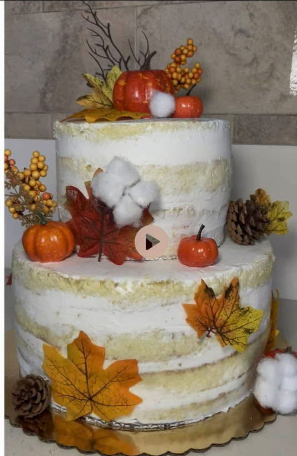 Two-tier autumn naked cake with pumpkins